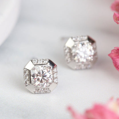 Sterling silver square stud earrings with clear round-cut stone, one earring in focus