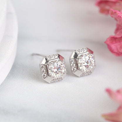 Sterling silver square stud earrings with clear round-cut stone and faceted halo detail