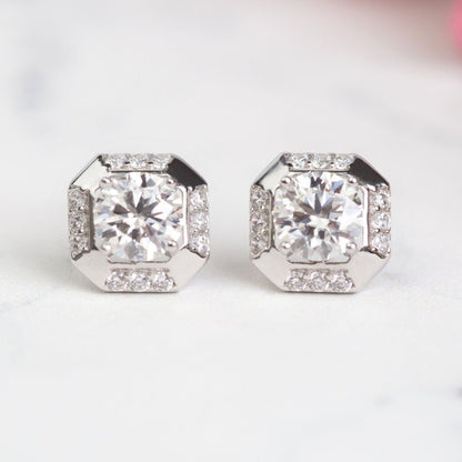 Sterling silver square stud earrings with clear round-cut stone in a faceted square setting