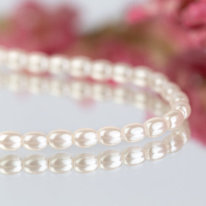 White pearl choker necklace with glossy oval pearl beads, close-up detail