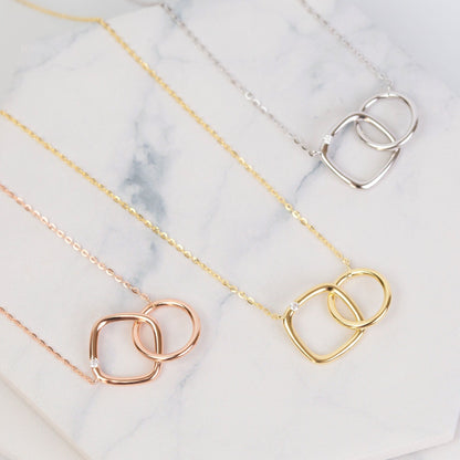 Linked circle and square pendant necklace in rose gold, gold, and silver tones