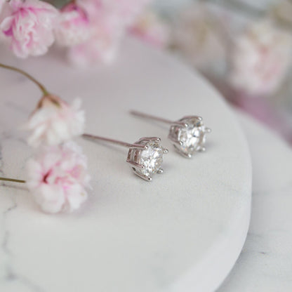 Round lab-grown diamond stud earrings with four-prong settings, white metal, side view