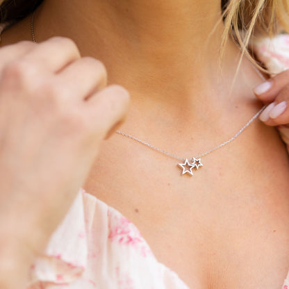 Silver star necklace with two star pendants on a delicate chain