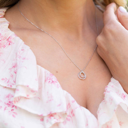 Silver rings necklace with small interlocking ring pendant and stone detail