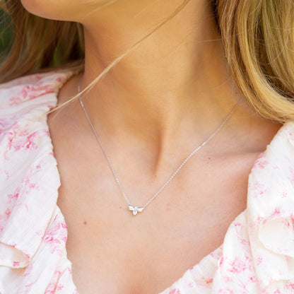 Silver firefly pendant necklace with wing-shaped setting and clear teardrop stone