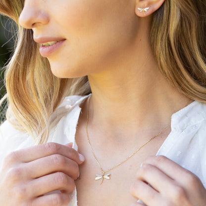 Gold dragonfly stud earrings with pavé crystal wings