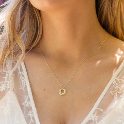 Gold rings necklace with small interlocking ring pendant