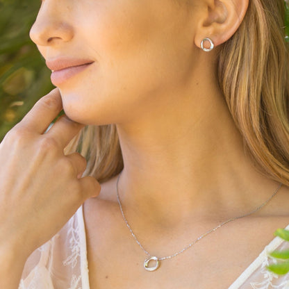 Sterling silver circle stud earring on ear, stone-inset round ring