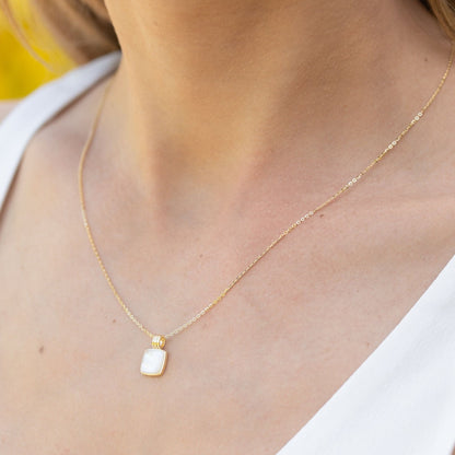 Gold pendant necklace with square mother-of-pearl charm and ribbed bail