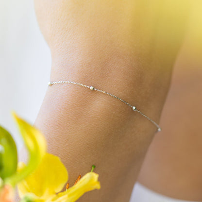 Silver satellite chain bracelet with small round beads and clasp on wrist