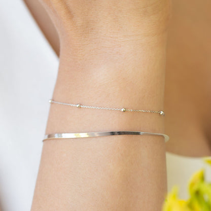 Silver satellite chain bracelet with round beads on wrist